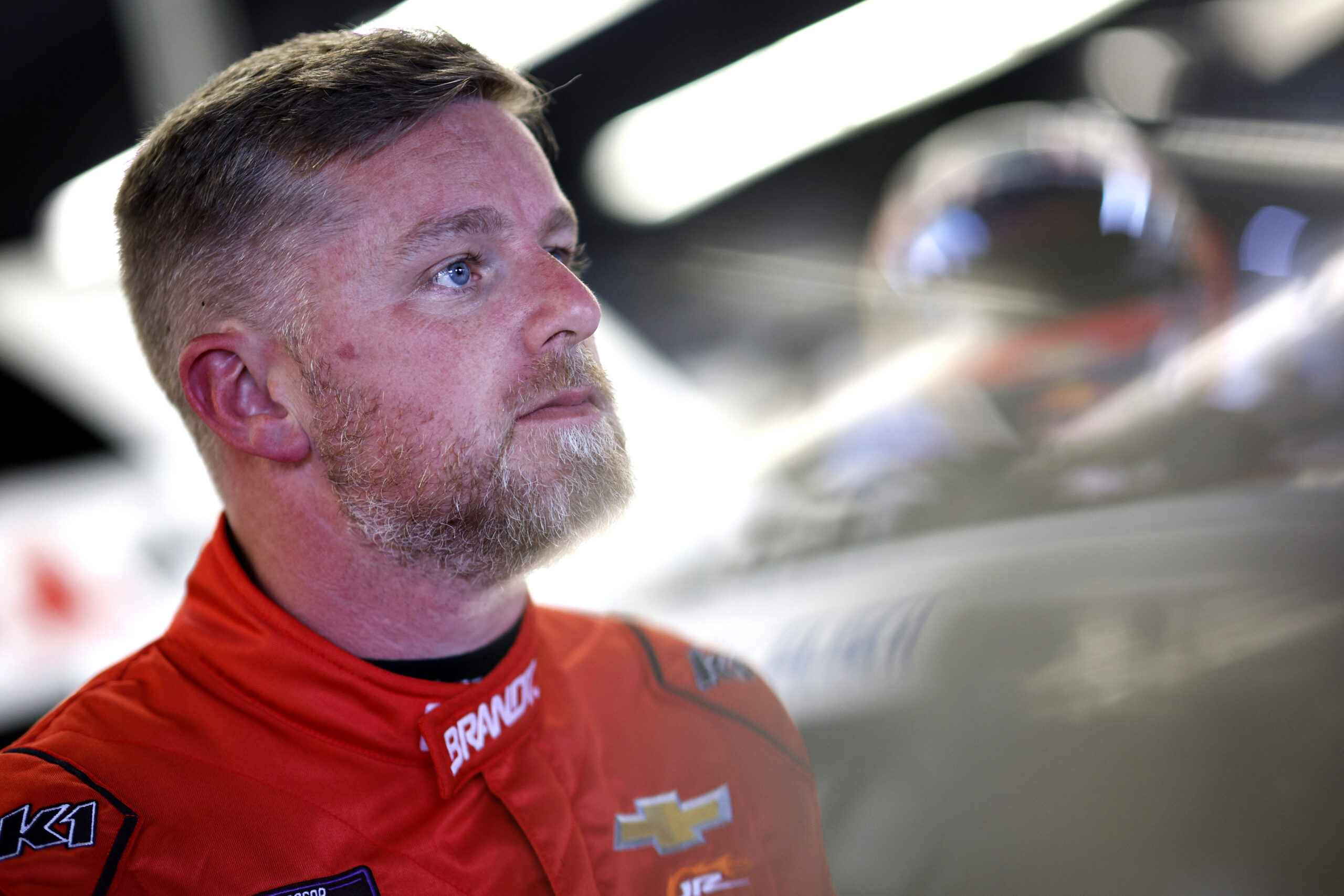 Credit: DAYTONA BEACH, FLORIDA - FEBRUARY 14: Justin Allgaier, driver of the #7 BRANDT Chevrolet looks on in the garage area during practice for the NASCAR Xfinity Series United Rentals 300 at Daytona International Speedway on February 14, 2025 in Daytona Beach, Florida. (Photo by Sean Gardner/Getty Images)